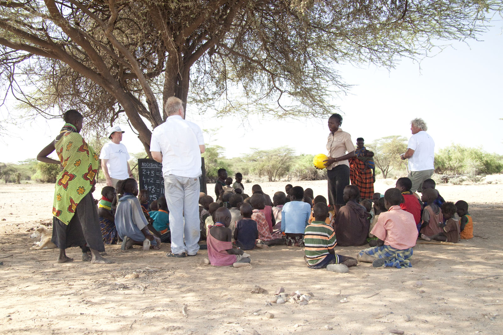 Open-air school under acacia tree